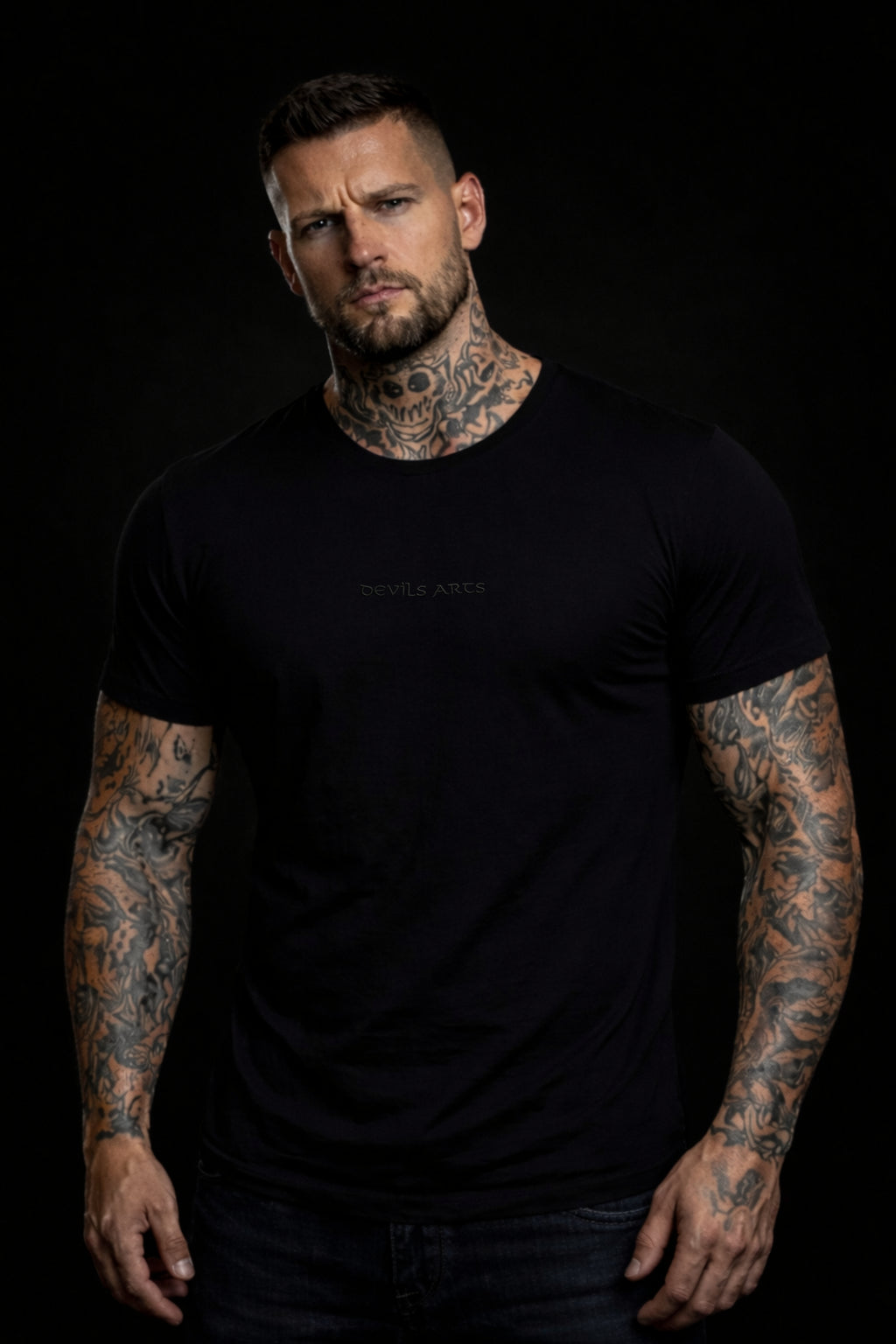 tattooed male model wearing black DEVILS ARTS blackout t-shirt dark tattoo streetwear