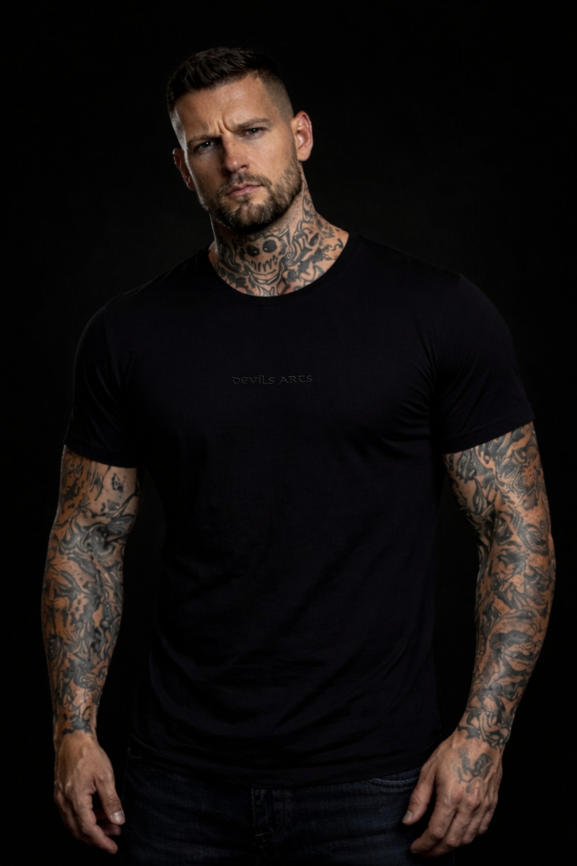 tattooed male model wearing black DEVILS ARTS blackout t-shirt dark tattoo streetwear