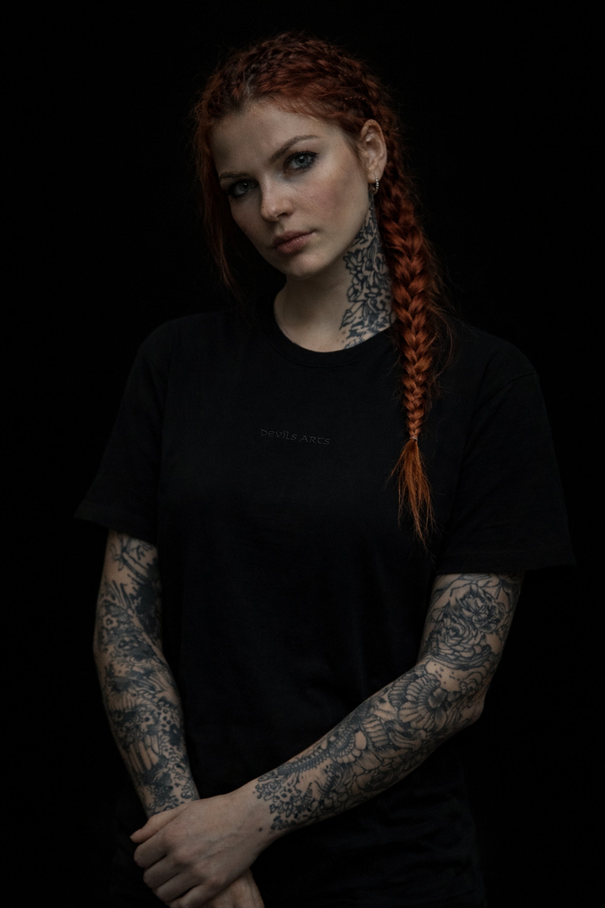 tattooed female model wearing black DEVILS ARTS tonal black embroidered logo t-shirt tattoo streetwear