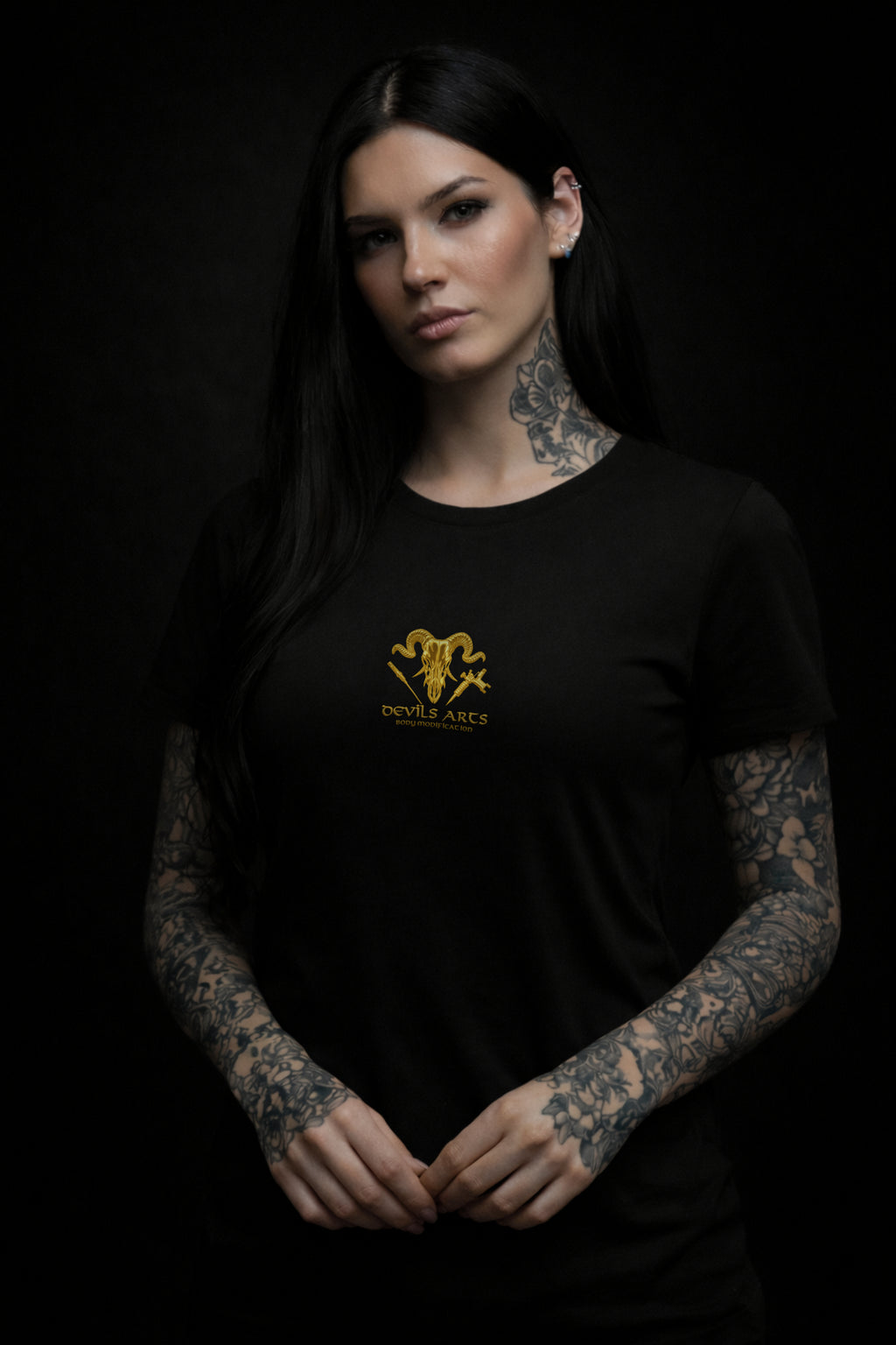 tattooed female model wearing black DEVILS ARTS gold skull logo t-shirt dark tattoo streetwear