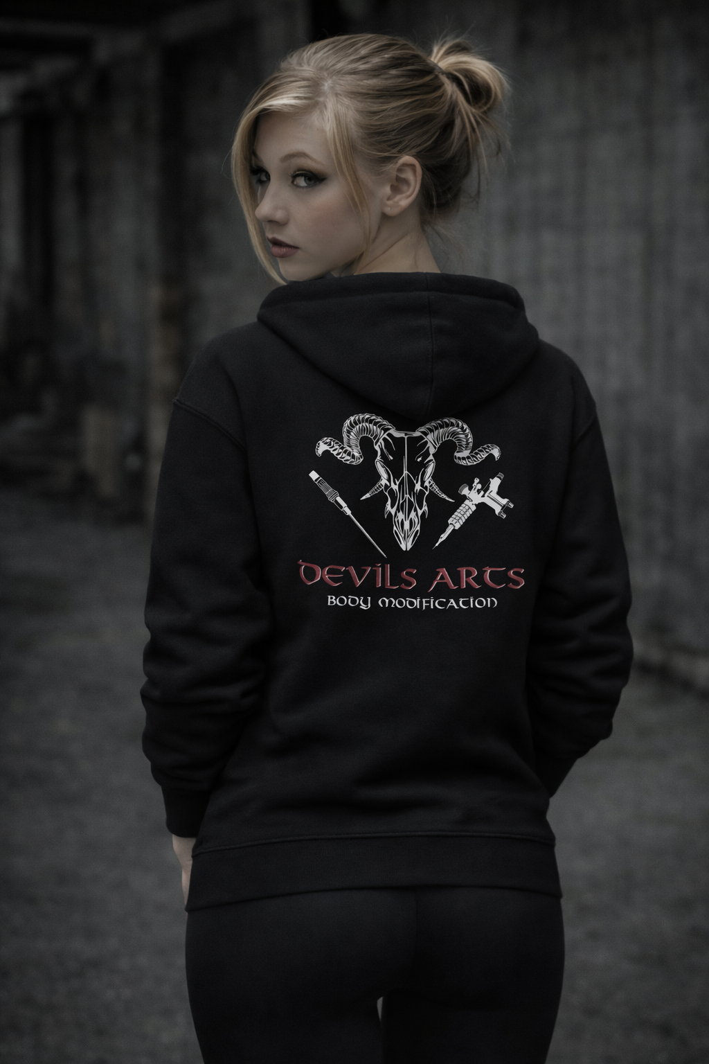 female model wearing black tattoo hoodie with DEVILS-ARTS skull logo back print tattoo culture