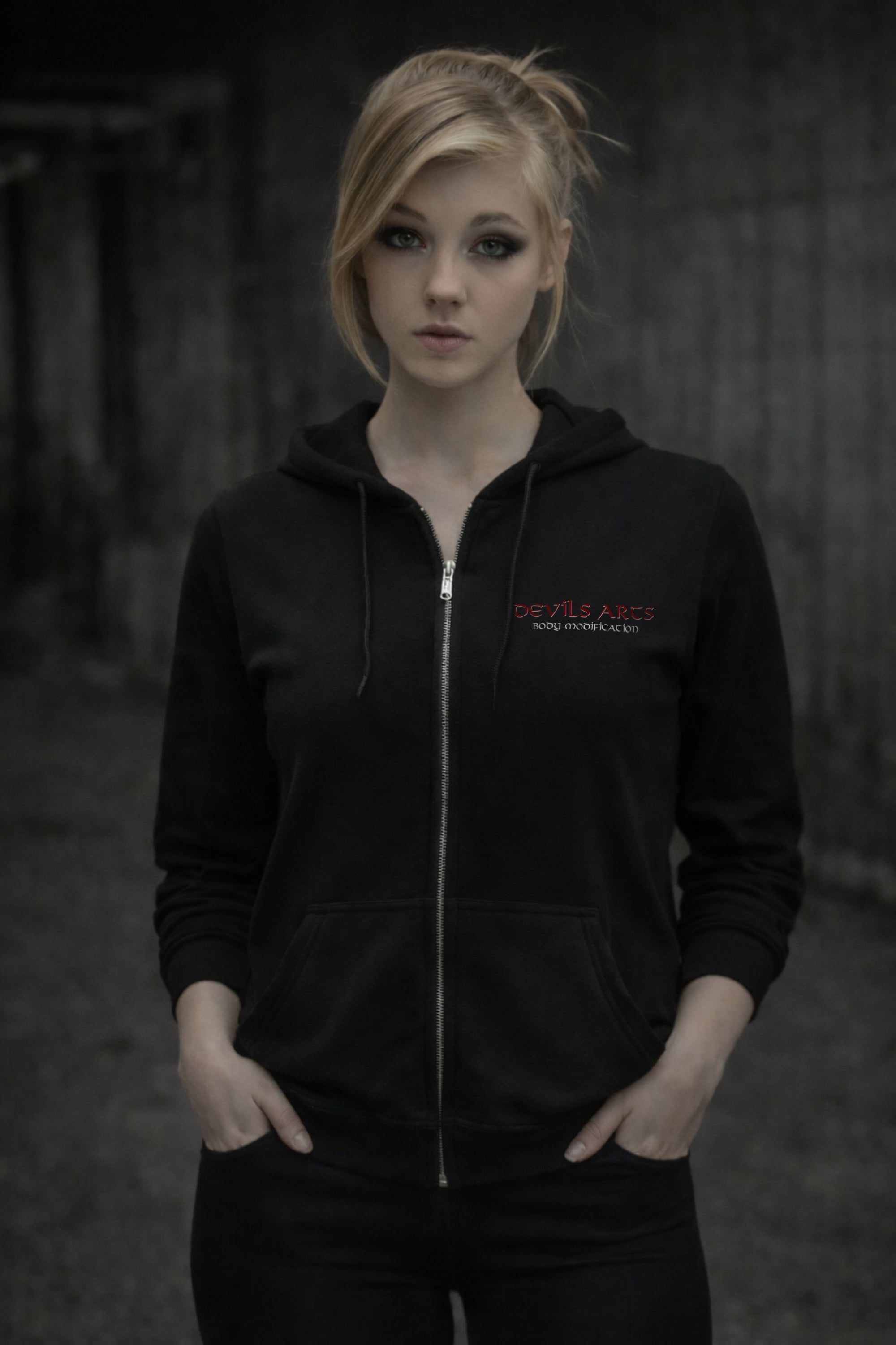 female model wearing black DEVILS-ARTS zip hoodie with small chest logo dark tattoo streetwear